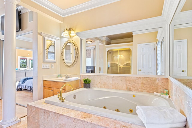 bathroom featuring crown molding, vanity, tiled tub, and ornate columns