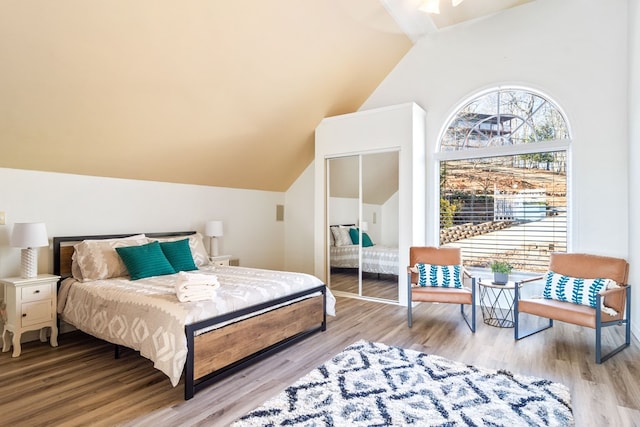 bedroom featuring hardwood / wood-style flooring and lofted ceiling