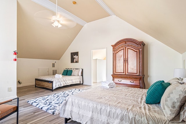 bedroom featuring crown molding, lofted ceiling, light wood-type flooring, and ceiling fan