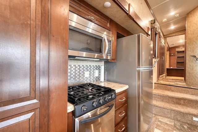 kitchen featuring decorative backsplash and appliances with stainless steel finishes