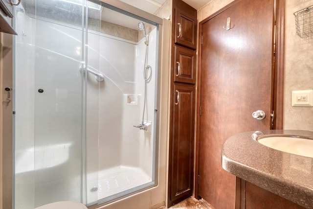 bathroom with sink and a shower with shower door