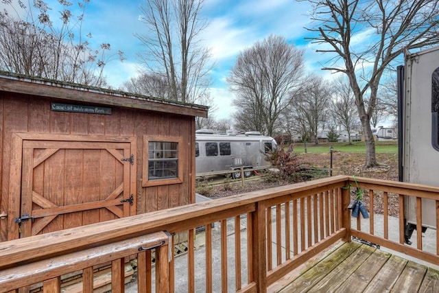 wooden terrace with a storage shed