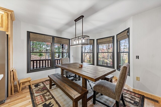 dining space featuring light wood-type flooring