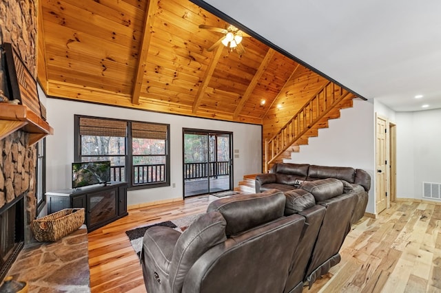 living room with high vaulted ceiling, a fireplace, light wood-type flooring, wooden ceiling, and beam ceiling