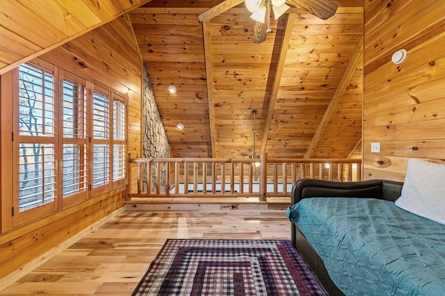 unfurnished bedroom with vaulted ceiling with beams, hardwood / wood-style floors, and wood walls