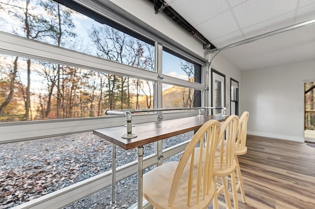 sunroom featuring a paneled ceiling