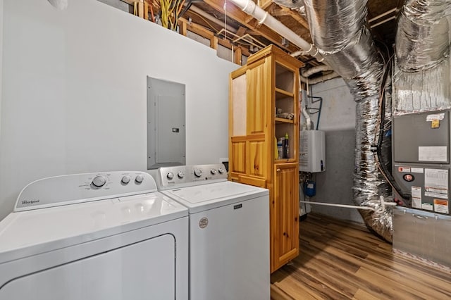 clothes washing area featuring cabinets, light hardwood / wood-style flooring, electric panel, independent washer and dryer, and water heater