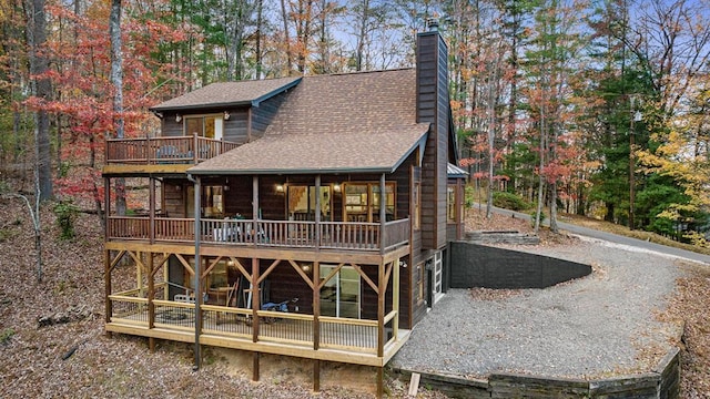 rear view of property featuring a deck