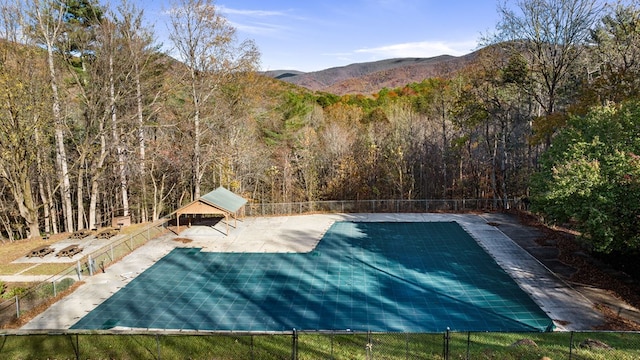 view of pool featuring a gazebo, a mountain view, and a patio area