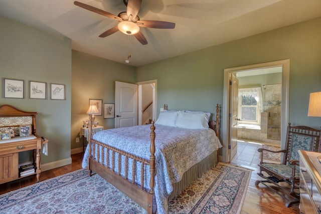 bedroom with hardwood / wood-style floors, ceiling fan, and ensuite bath