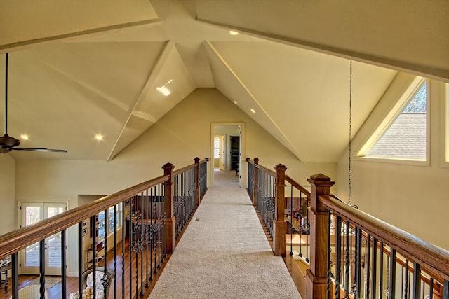 corridor featuring light carpet and vaulted ceiling