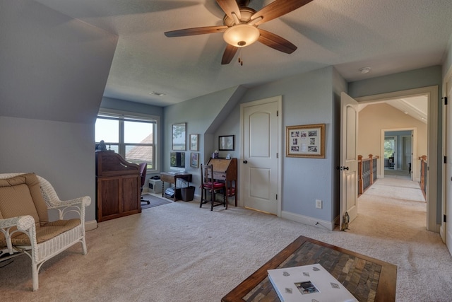 interior space with a textured ceiling, ceiling fan, lofted ceiling, and light carpet