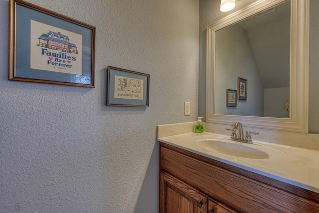 bathroom featuring vanity and vaulted ceiling