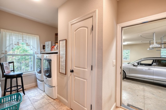 washroom featuring plenty of natural light and washer and dryer