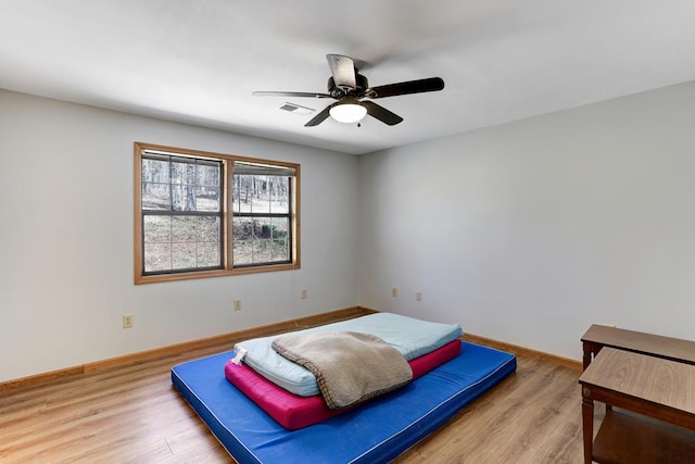 bedroom featuring light hardwood / wood-style flooring and ceiling fan