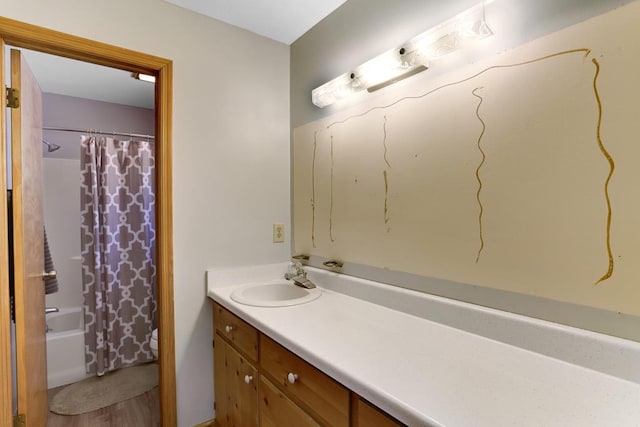 bathroom featuring hardwood / wood-style floors, shower / tub combo, and large vanity