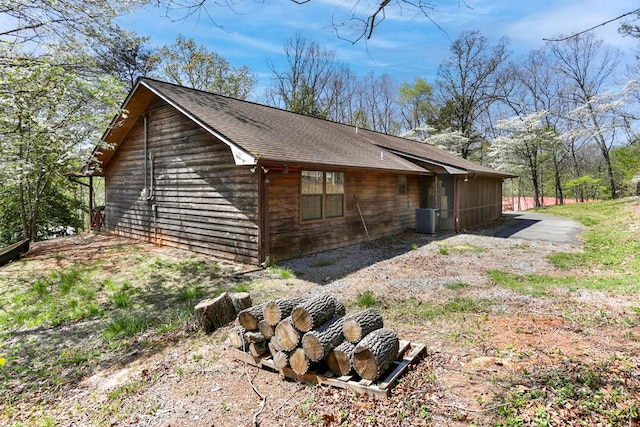 view of side of home with central AC unit