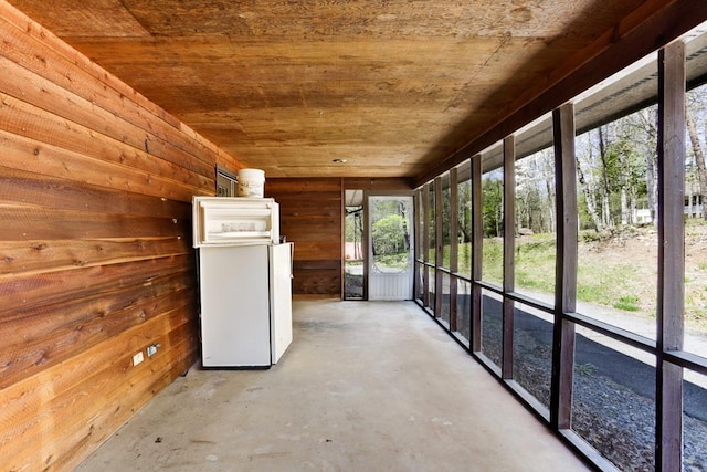 unfurnished sunroom with wooden ceiling