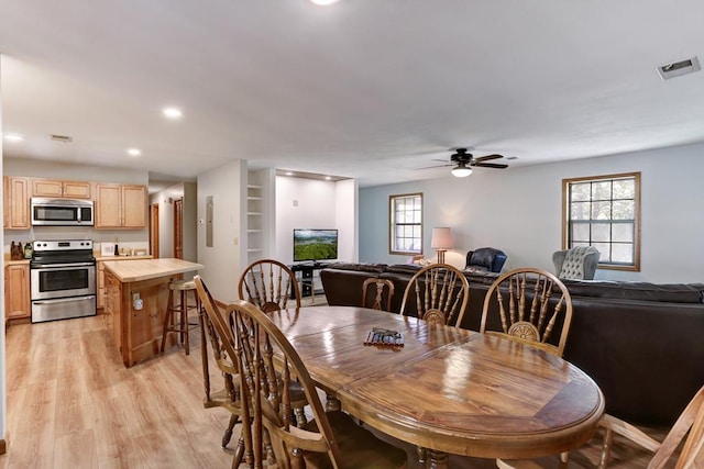 dining area featuring light hardwood / wood-style floors and ceiling fan