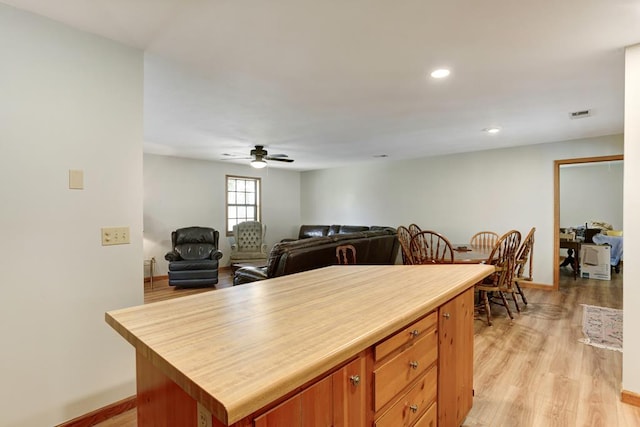 kitchen with a center island, ceiling fan, and light hardwood / wood-style floors