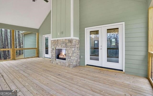 deck featuring a fireplace and french doors