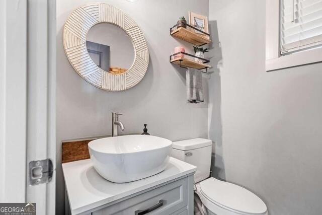 bathroom featuring vanity and toilet