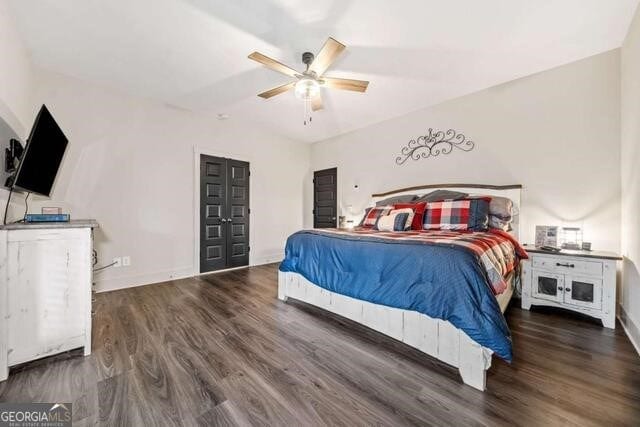 bedroom featuring ceiling fan and dark wood-type flooring