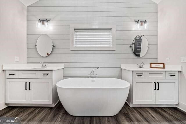 bathroom with a bathtub, lofted ceiling, and vanity