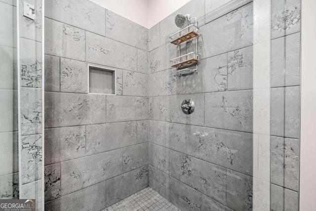 bathroom with tiled shower