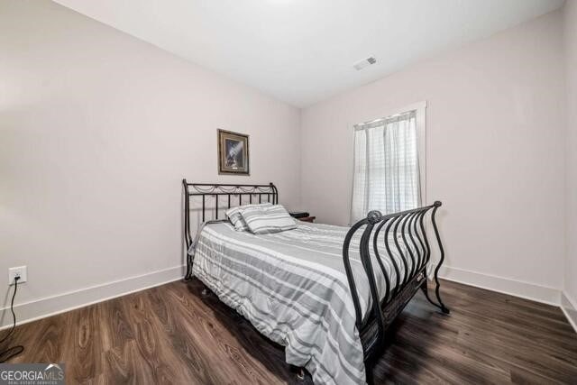 bedroom featuring dark hardwood / wood-style flooring