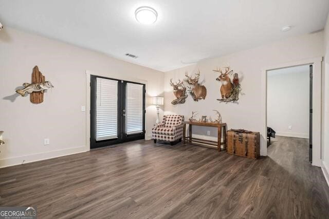 unfurnished room with dark hardwood / wood-style flooring and french doors