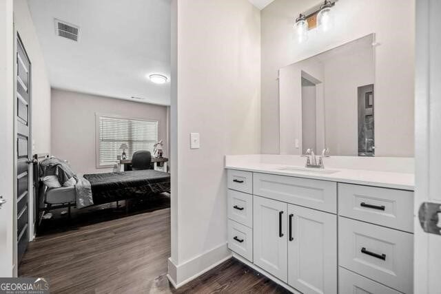 bathroom with vanity and hardwood / wood-style flooring