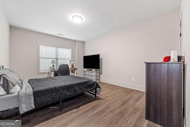 bedroom with wood-type flooring