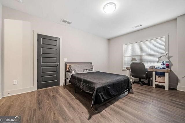 bedroom with hardwood / wood-style flooring and pool table