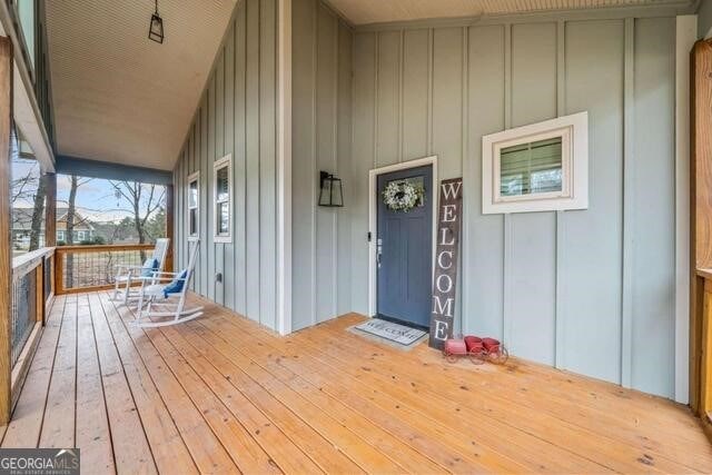 wooden terrace featuring covered porch