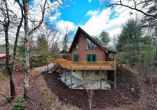 rear view of house with a deck and a patio area