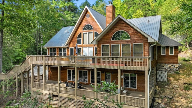 rear view of property featuring a deck