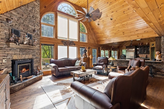 living room with a fireplace, ceiling fan, high vaulted ceiling, and a wealth of natural light