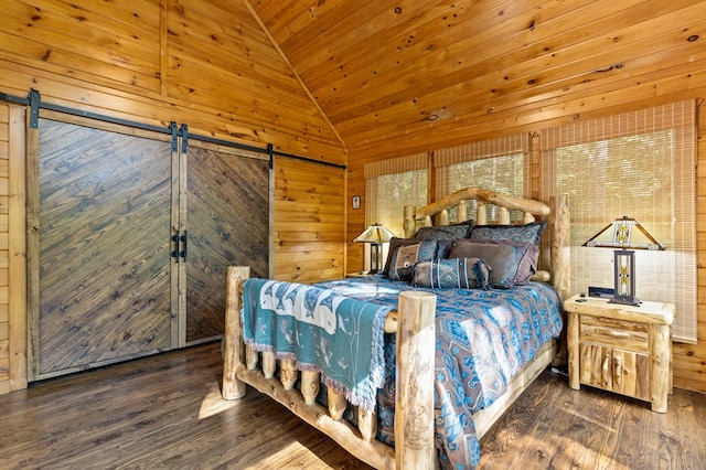 bedroom featuring wooden walls, dark hardwood / wood-style floors, wooden ceiling, and a barn door