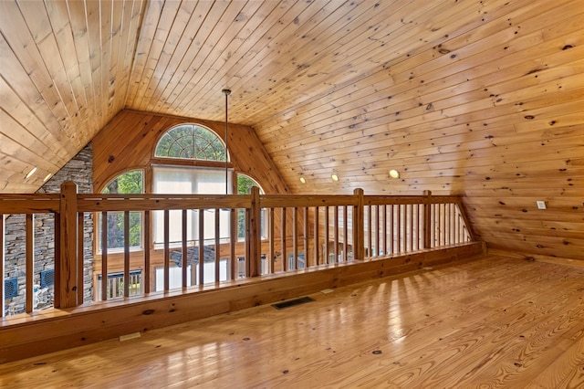 bonus room featuring light wood-type flooring, wood walls, lofted ceiling, and wooden ceiling