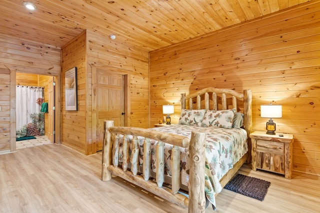 bedroom featuring wooden ceiling, wood walls, and light hardwood / wood-style flooring