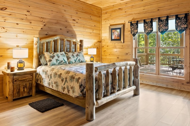 bedroom with wood ceiling, light hardwood / wood-style floors, and wooden walls