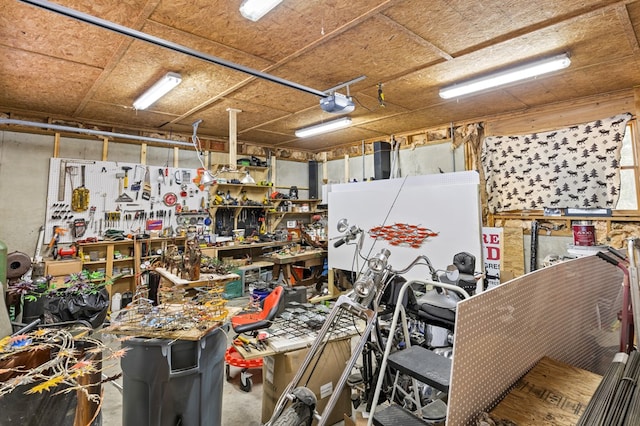 garage with a garage door opener and a workshop area