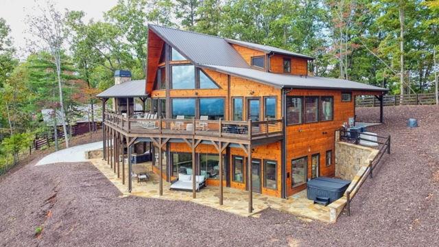 rear view of house with a deck and a patio area