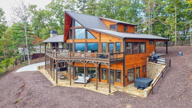 back of property with a patio area, fence, and a wooden deck