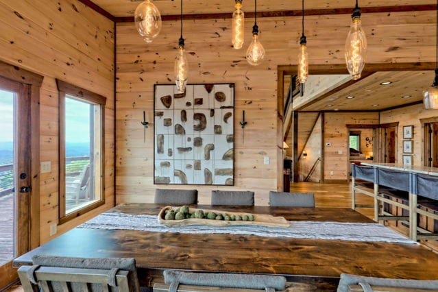 dining space with wood finished floors and wooden walls