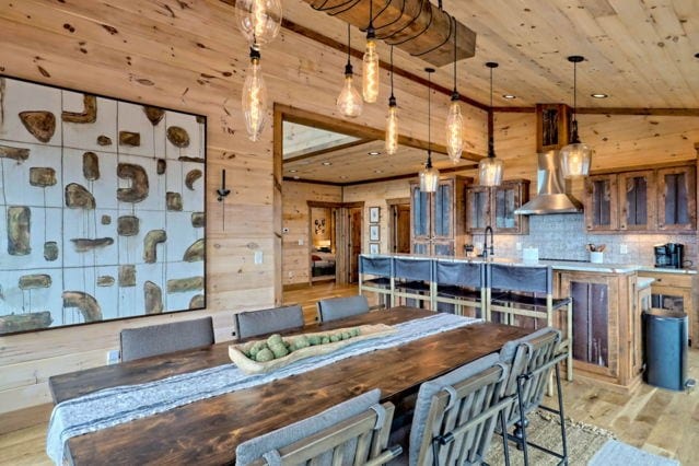 dining area featuring wooden walls, light wood-style flooring, and wooden ceiling