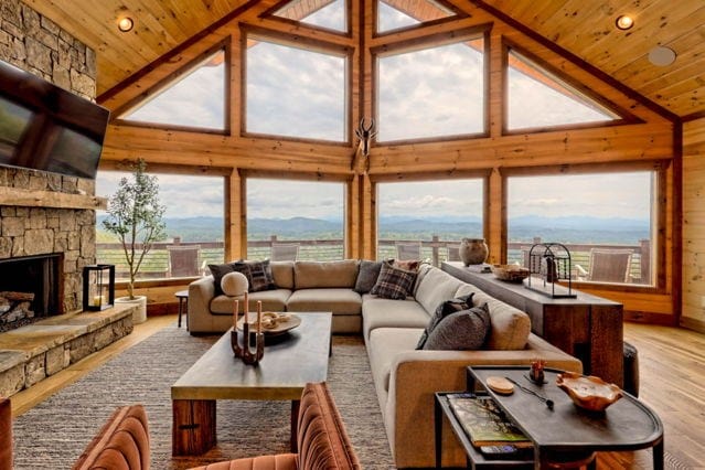 living area with a mountain view, wooden ceiling, wood finished floors, and a fireplace
