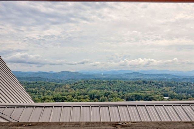 view of mountain feature with a wooded view