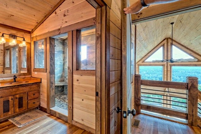 bathroom featuring vanity, vaulted ceiling, wooden walls, hardwood / wood-style floors, and wooden ceiling